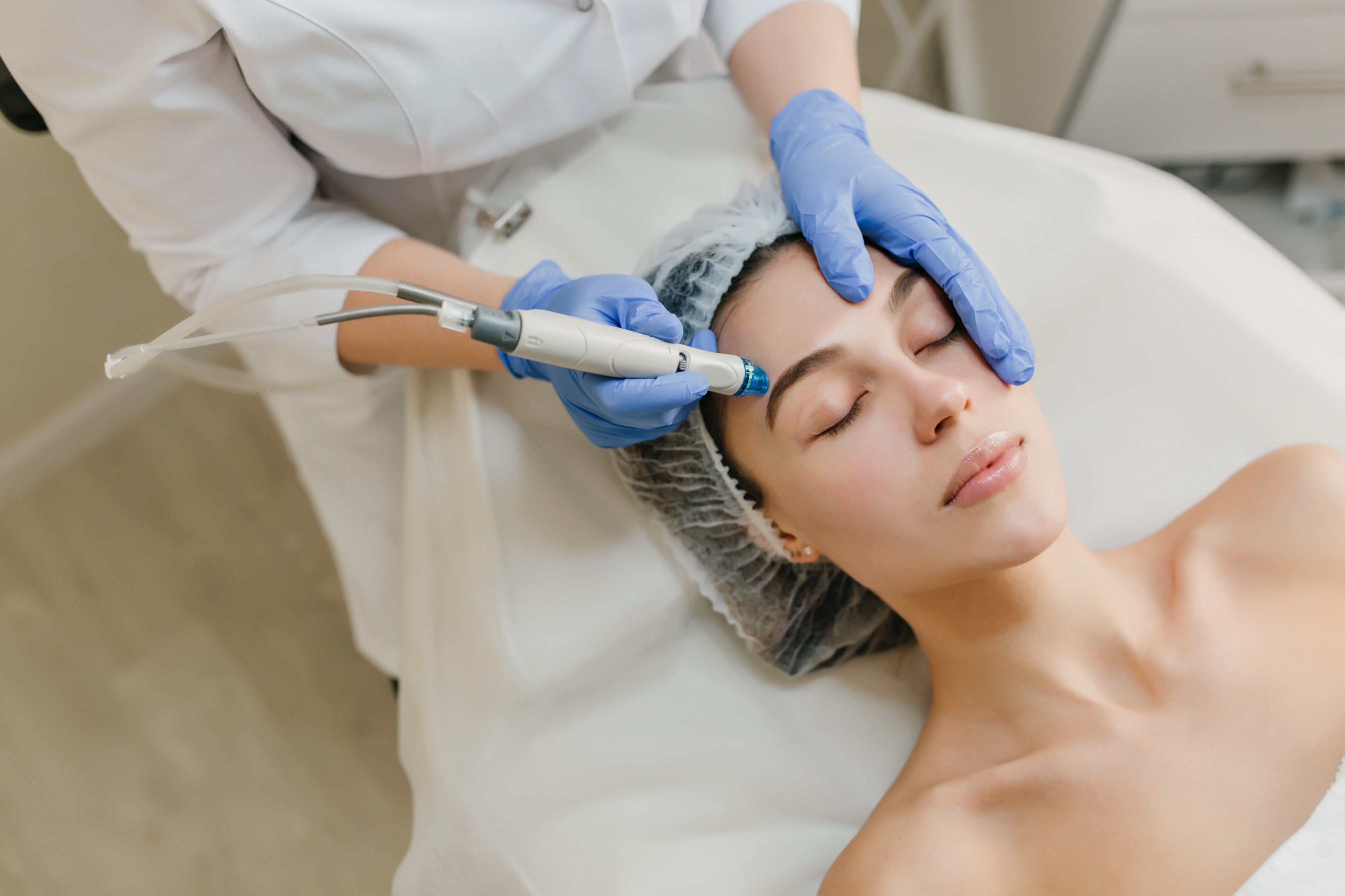 view-from-rejuvenation-beautiful-woman-enjoying-cosmetology-procedures-beauty-salon-dermatology-hands-blue-glows-healthcare-therapy-botox (1)